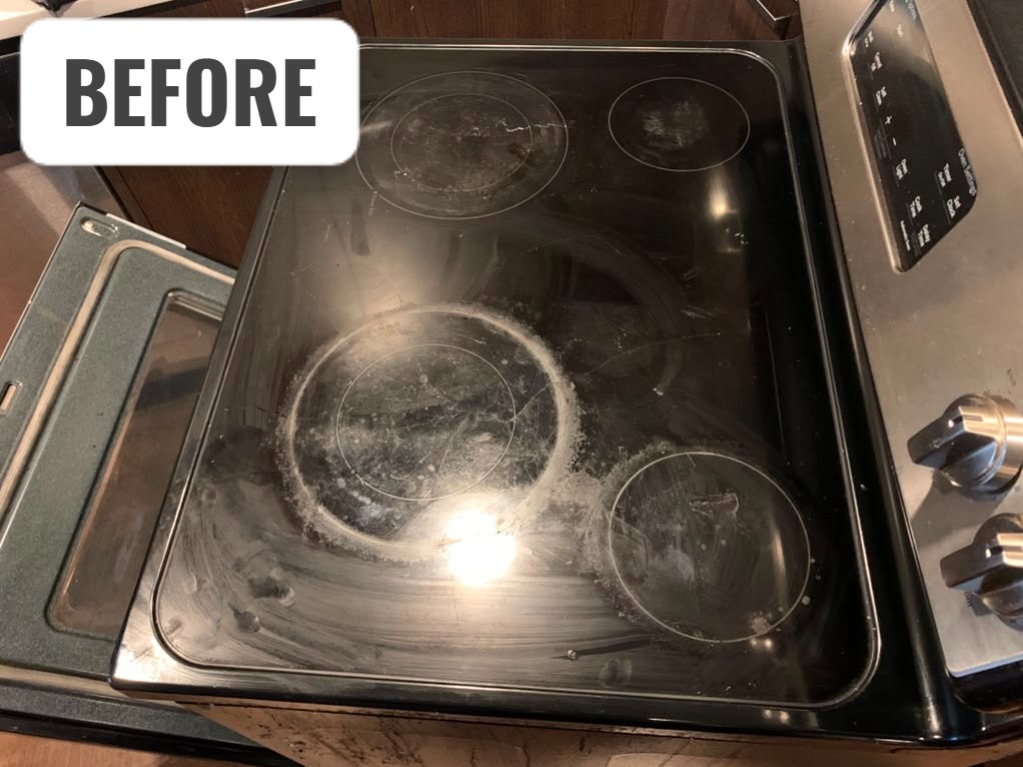 Electric glass cooktop before repair showing visible wear and damaged cooking surface